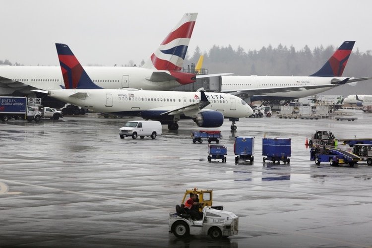 Aviones de Delta Airlines y un avión de British Airways se muestran en el Aeropuerto Internacional de Seattle-Tacoma, el día en que el CEO de Delta, Ed Bastian, dijo a los empleados que reduciría el 40% de la capacidad en los próximos meses, el más grande de la aerolínea historia (Reuters)