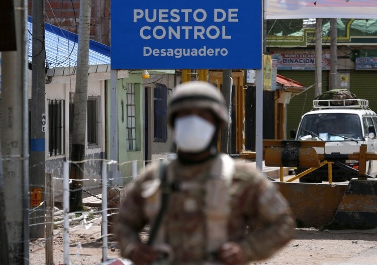 A Peruvian soldier stands at the check point in border line between Peru and Bolivia after Peru