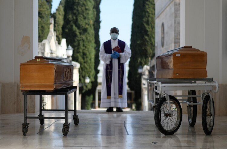 Los ataúdes de dos víctimas de coronavirus, en un entierro en Cisternino, Italia (Reuters)