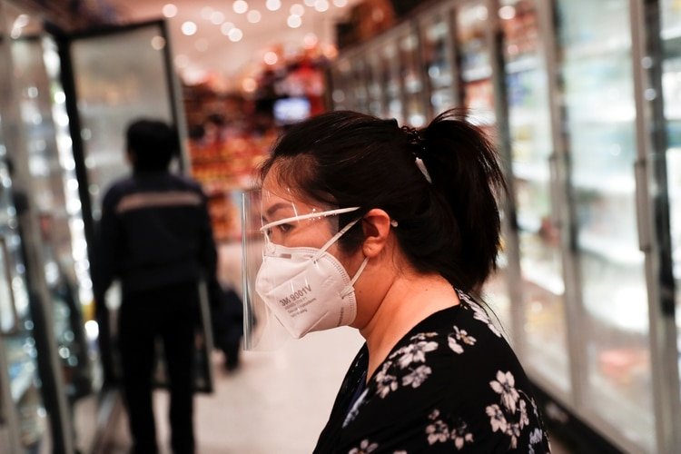 A woman walks wearing a protective mask and a face shield inside a supermarket during the coronavirus disease (COVID-19) outbreak in Bangkok, Thailand, April 9, 2020. REUTERS/Jorge Silva