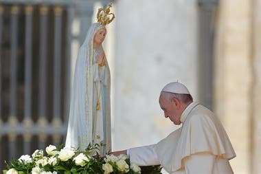 El Papa Francisco tocando el manto de la virgen de Fátima en su santuario