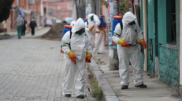 Trabajadores fumigan calles. | EFE