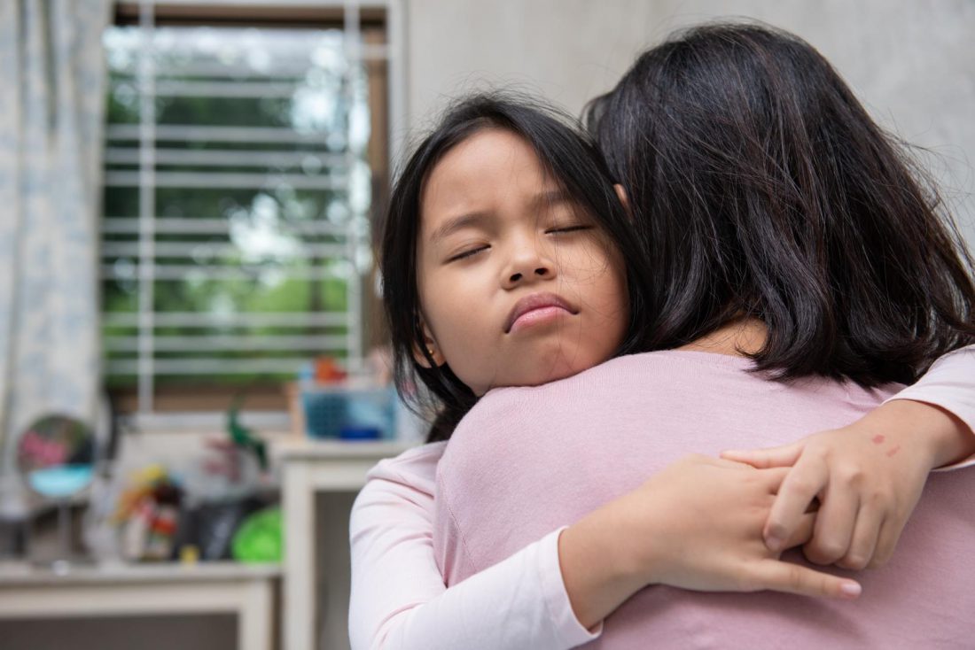[NOTE: This is a stock image.] Mother and daughter hug tightly.